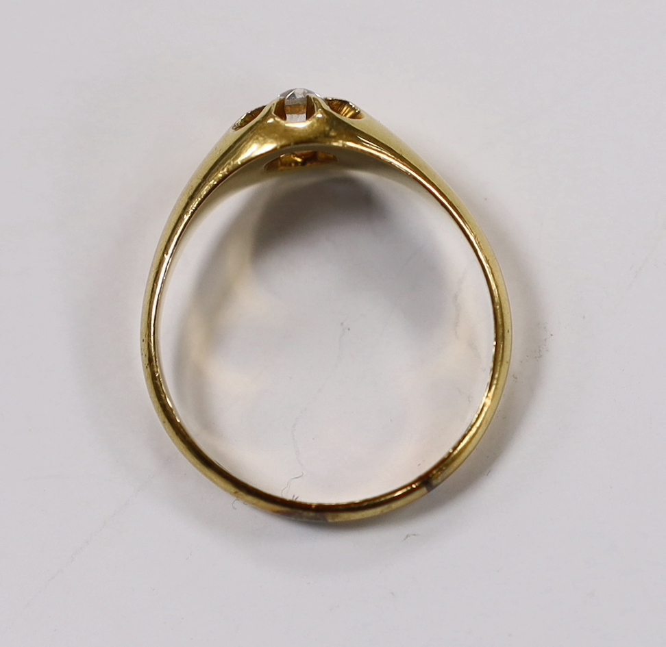 A late Victorian 18ct gold and claw set solitaire diamond ring, size U, gross weight 4.7 grams.